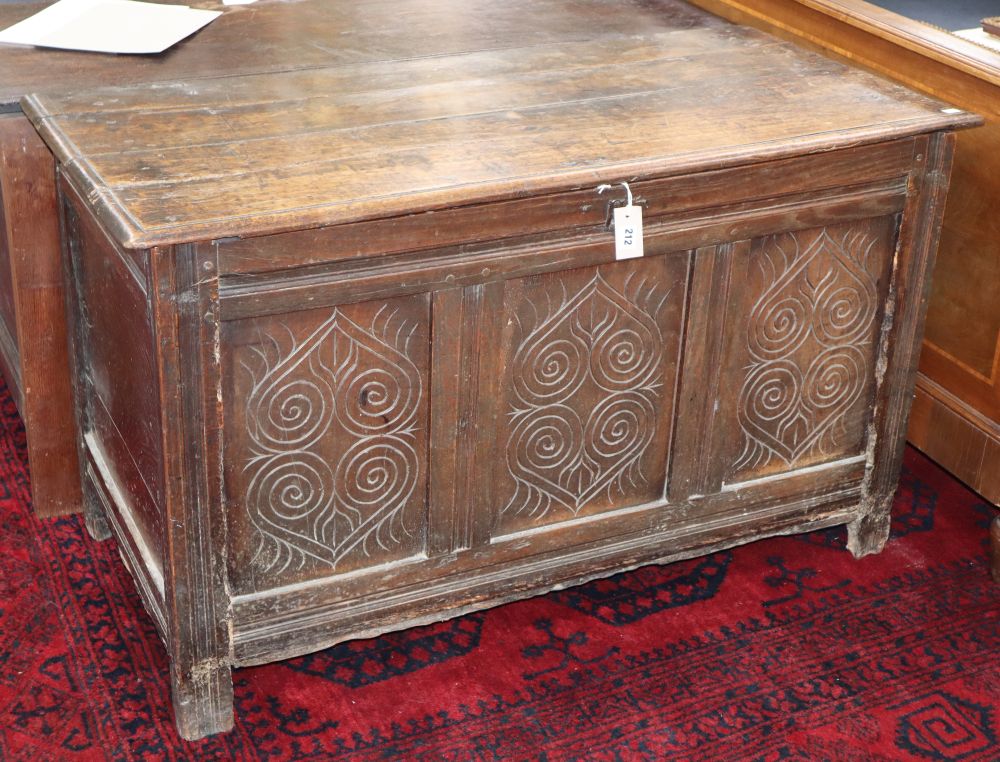 A 17th/18th century carved and panelled oak coffer, W.120cm